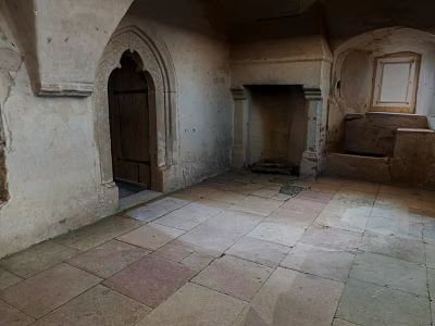 Ancient Interior Featuring Wooden Door Stone Fireplace And Stone Floor Design 3d model