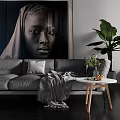 Gray Multi Seater Sofa With Throw Blanket Round Coffee Table And Large Green Plant