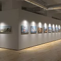 Cultural Center Exhibition Hall With Modern Interior Wooden Floors And Displayed Artworks