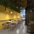 Bright Dessert Shop Interior Featuring Glass Display Cases Pastries Green Plants And Decorative Bicycle