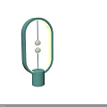 Two Turquoise Oval Shaped Table Lamps With Yellow Light And Silver Spherical Decorations