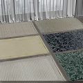 Textured Square Rugs In Various Colors And Patterns On Bright Floor With Natural Light