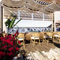 Beachfront Guesthouse Building With Wooden Deck Deck Chairs Large Windows Palm Trees And Ocean View