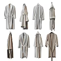 Different Styles of Neutral Colored Robes Hanging on Hangers Including Bathrobes and Long Cardigans