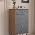 Wooden Chest of Drawers Featuring Dark Blue Drawers Golden Handles And Top Vase Books Clock