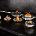 Decorative Garden Ornaments With Flames In Various Designs On Black Marble Surface