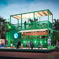 Green Container Café With Two Story Structure Outdoor Terrace And Lush Greenery