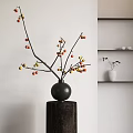Ornamental Decor Set with Black Spherical Vase Branches Red Yellow Fruits on Dark Cylindrical Base