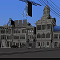 Scenic Commercial Street with Classic White Buildings Clock Tower and Billboards Under Blue Sky
