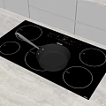 Modern Kitchen Black Induction Cooktop With Pan On Light Countertop And White Cabinets