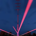 Tall Road Infrastructure Illuminated with Purple Lights Against Night Sky with Flying Bird
