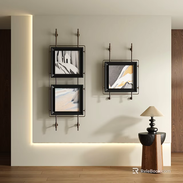 Three Abstract Paintings Black Frames Hanging On Light Colored Wall With Small Table And Lamp 3d model 
