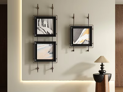 Three Abstract Paintings Black Frames Hanging On Light Colored Wall With Small Table And Lamp 3d model