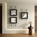 Three Abstract Paintings Black Frames Hanging On Light Colored Wall With Small Table And Lamp 3d model