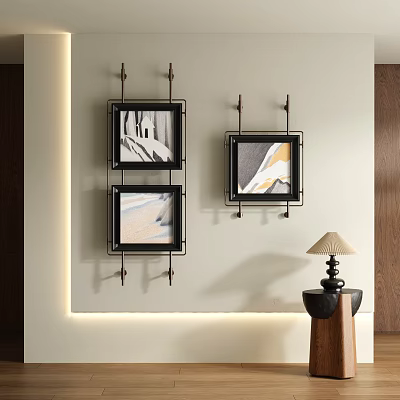 Three Abstract Paintings Black Frames Hanging On Light Colored Wall With Small Table And Lamp 3d model