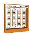 Art Cake Window Display Featuring Various Cakes in Glass Cases with House of Art Logo