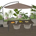 Outdoor Table with Rattan Chairs and Beige Umbrella Surrounded by Green Plants and Flowers
