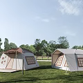 Beige And Light Gray Canvas Tents On Green Grass With Trees In Background
