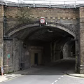 Brick Arch Road Tunnel Entrance With Historical Brick Structure And Signage