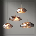 Three Modern Transparent Cloud Shaped Chandeliers Hanging Lit Against Grey Background