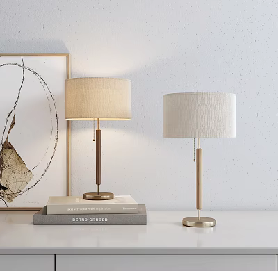 Stylish Table Lamps With Beige Shades Wooden Metal Poles Brass Bases Stacked Books Wall Art 3d model