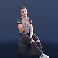 Woman Sitting On Chair Holding Smartphone Wearing Gray Top And Tight Pants