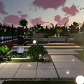Courtyard Garden Featuring Sunset Sky Black Iron Fence Lush Plants Round Lighting And Illuminated Steps