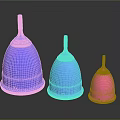Three Different Colored Menstrual Cups Arranged In A Row On Dark Background