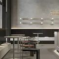 Modern Minimalist Café Interior With Round Tables Chairs Wall Lights And Glass Display Case