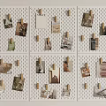 Photo Wall with White Perforated Board and Wooden Clips Holding Various Photos and Cards