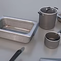 Stainless Steel Kitchenware with Baking Pans Pots Bowls Lids Measuring Cups Neatly Arranged