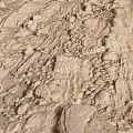 Natural Rocky Surface Featuring Layered Textures And Scattered Small Stone Fragments