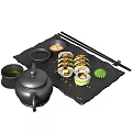 Sushi Rolls On Black Slate Tray With Chopsticks Soy Sauce Wasabi Teapot And Perilla Leaf