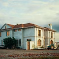 Classical Detached Villa White Exterior Red Tile Roof Arched Windows And Vintage Truck