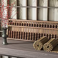Wooden Abacus Green Vase with Red Flowers Rolled Bamboo Mats and Wooden Lattice Screen