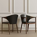 Stylish Black Dining Chairs With Curved Backrest And Wooden Legs Against Paneled Walls And Floor