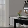 Modern Bathroom With Round Gold Framed Mirror Black Countertop Vanity White Sinks And Green Plants
