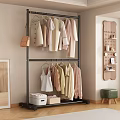 Double Layer Metal Clothes Rack With Light Colored Garments Storage Boxes And Wall Decor
