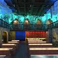 Cave Themed Restaurant Interior With Two Story Dining Area Bricked Benches And Colorful Lighting