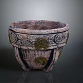 Vintage Terracotta Plant Pot Featuring Carved Patterns and Natural Moss Growth