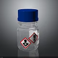 Transparent Glass Bottle With Blue Cap And Warning Hazard Symbols For Household Use