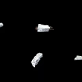 Multiple White Stone Fragments Scattered On Black Background With Various Shapes