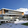 Modern School Building Exterior With Large Glass Windows Open Plaza And Greenery