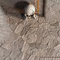 Natural Gray Stone Pavement With Irregular Slabs And Ornate Carved Sculpture