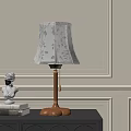 Elegant Table Lamp With Floral Shade Wooden Base On Dark Cabinet And White Bust Sculpture