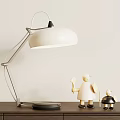 Modern Table Lamp With White Lampshade Metal Arm And Black Base With Decorative Figurines