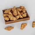 Freshly Baked Croissants in Wooden Tray with Some Scattered Around