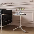 Modern Side Table with Black Chair Vase Flowers on Light Colored Wall Wooden Floor