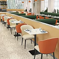 Modern Restaurant Interior With Orange Beige Chairs Marble Tabletops And Green Booth Seats