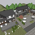 Scenic Traditional Guesthouse Building With Courtyard Outdoor Umbrellas Seating Greenery And Stone Pavement